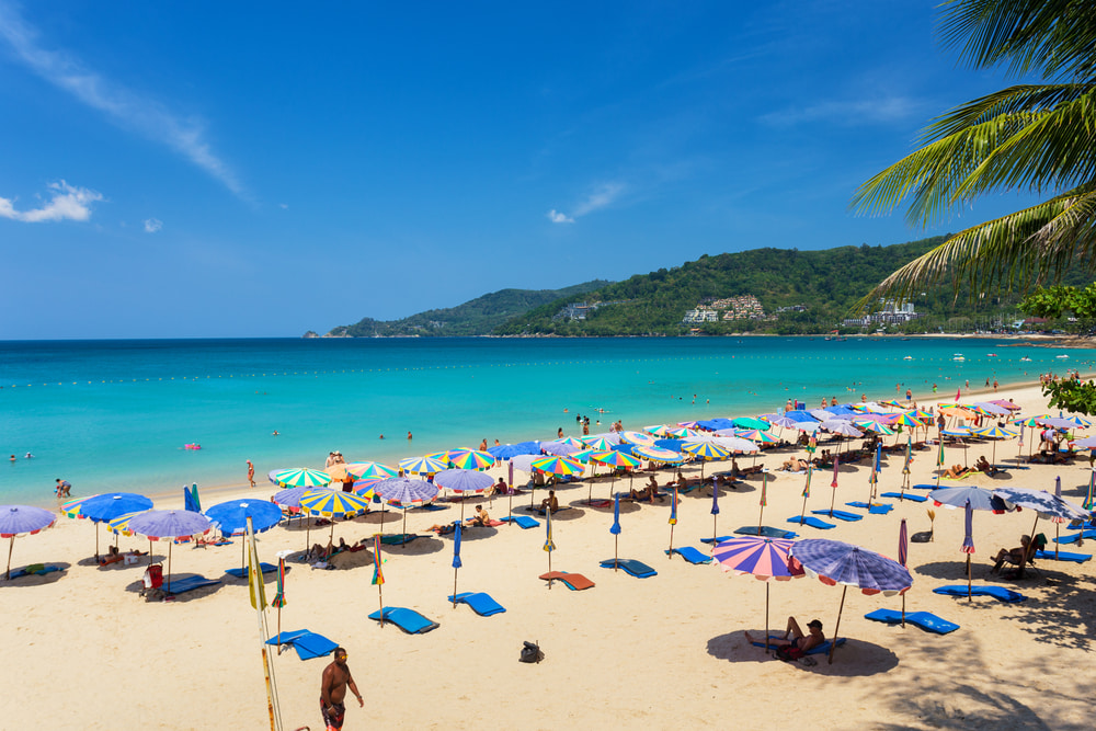 Sunbeds and umbrellas set up along Patong Beach in Phuket, Thailand