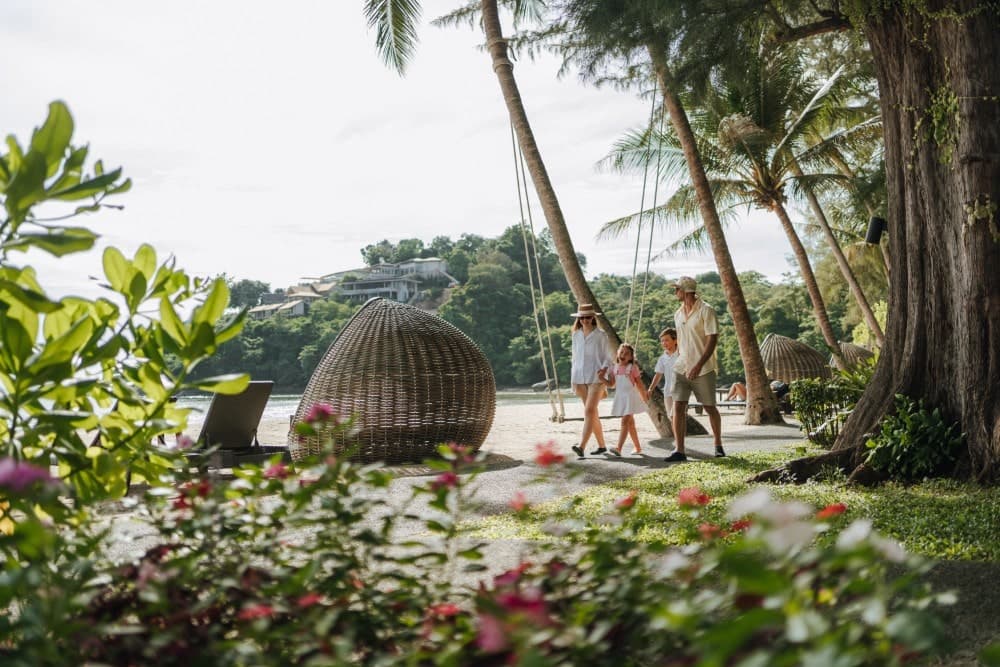A family enjoying Thavorn Beach Village’s resort grounds