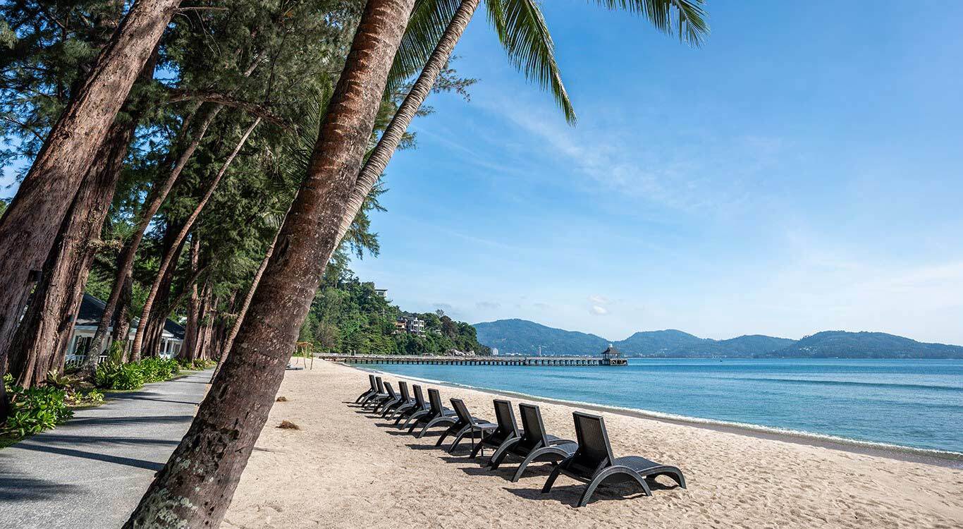 Nakalay beach lined with rows of tropical pine trees
