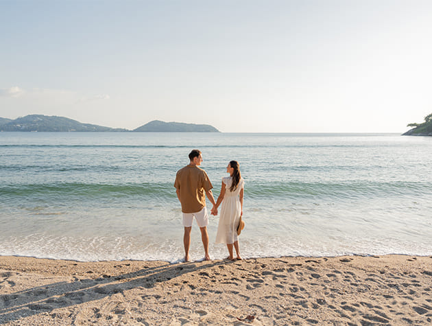 A couple enjoying the beach at Thavorn Beach Village Resort & Spa in Phuket